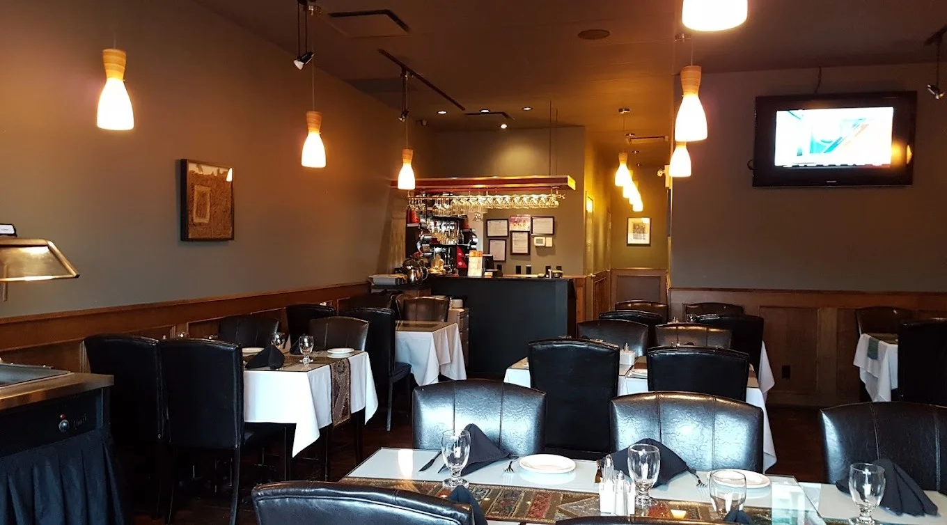 Fresh homemade Indian pickles - Mango, Garlic, and Lemon pickle jars at Green Chili Fine Indian Cuisine Calgary